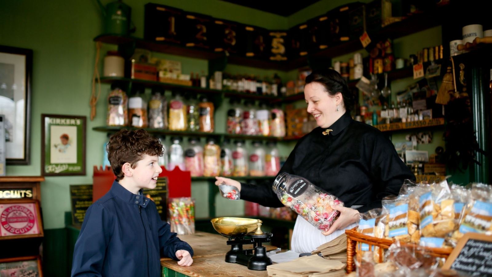 A young boy enjoying an outing to the Ballycultra Sweet Shop in the Ulster Folk Museum, Cultra